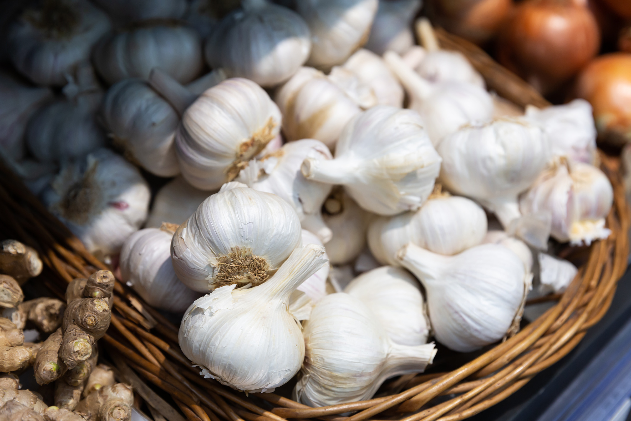 Garlic in a basket on supermarket shelf
