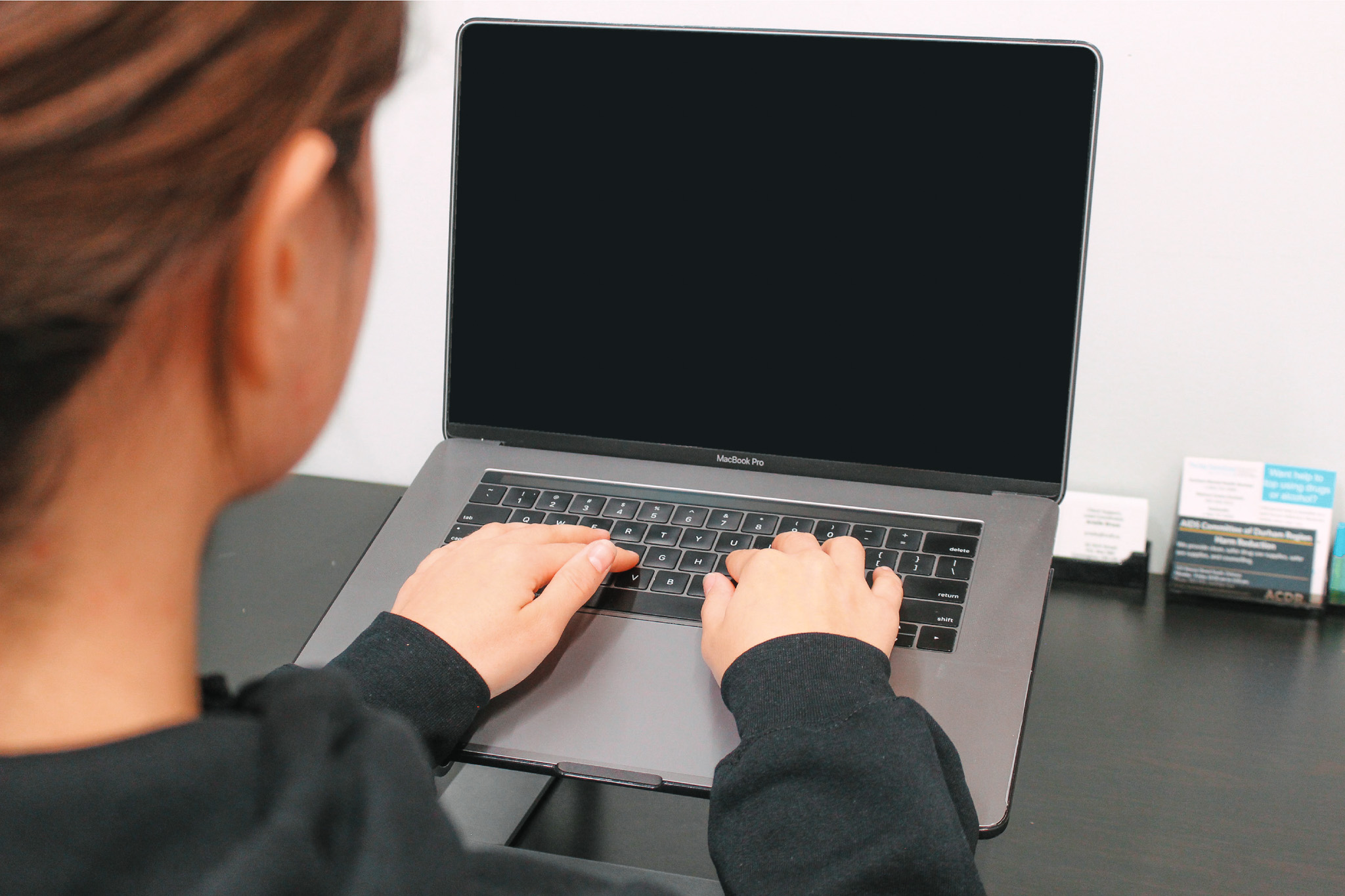 A staff member working on a blank computer