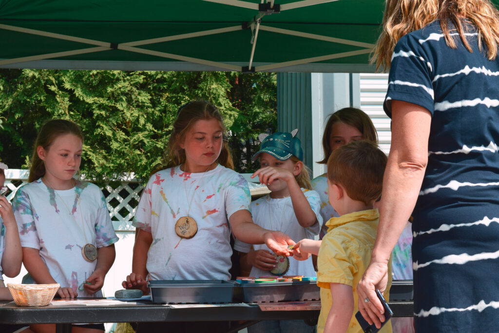 Participants of our Farmers Market Summer Kids Camp sell handmade goods to customers.