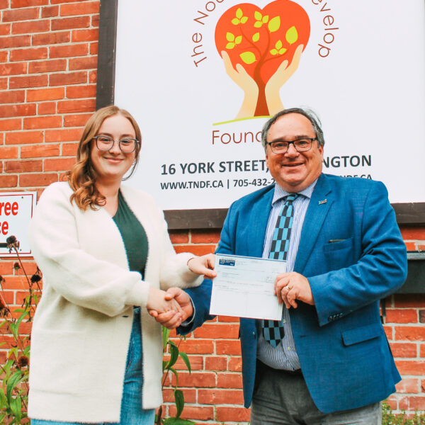 Interim Executive Director Jess and Mayor Walter Schumer pose with a cheque donation made in the name of the Brock Beats Hunger campaign.