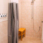 shower room with shower curtain and stool