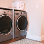 washer and dryer with laundry basket ontop