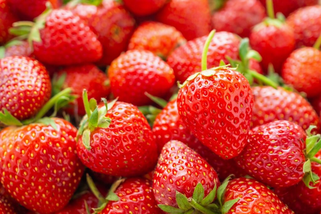 Fresh organic red ripe Strawberry fruit background closeup