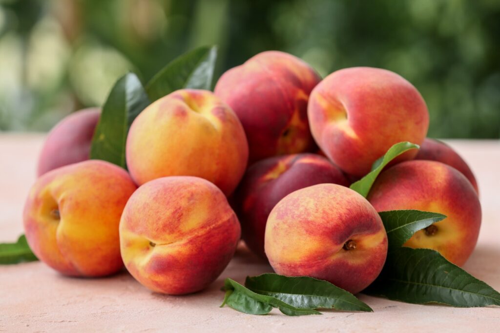 Ripe peaches on table in garden
