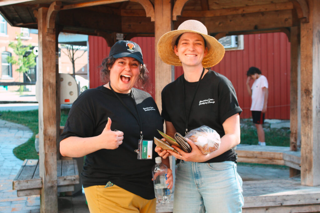 Team members Beth and Kate smile happily during Night Market
