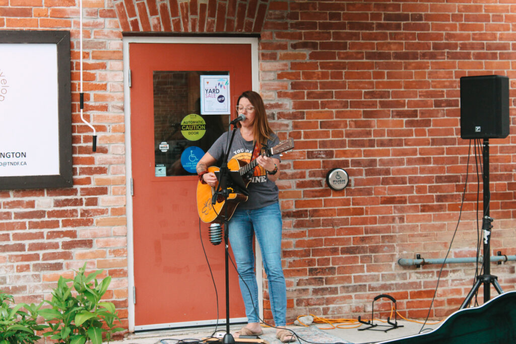 Erin Blackstock plays the guitar at our Night Market -May 2024