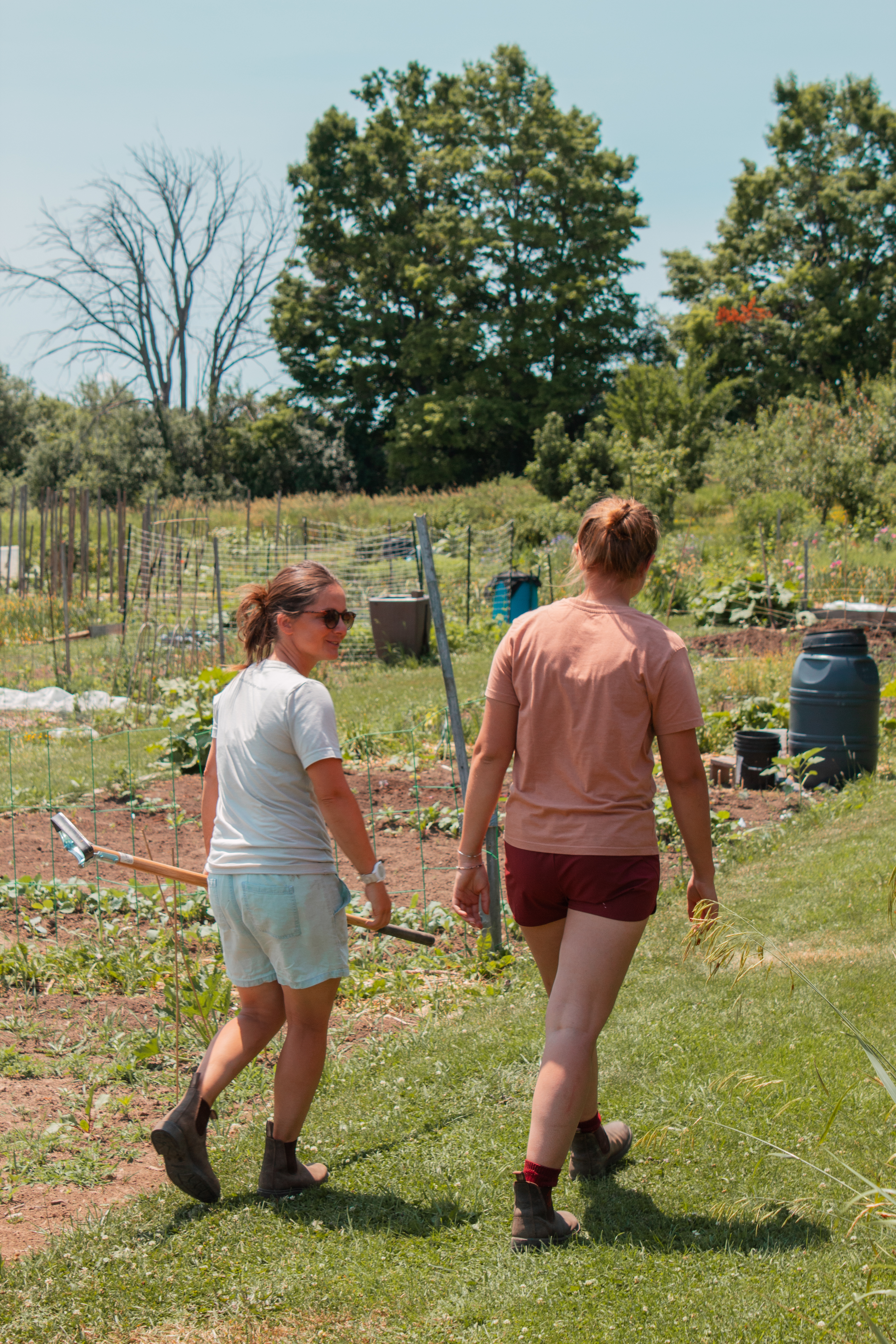 Kristin and Emily walk through Maple Tree Community Garden