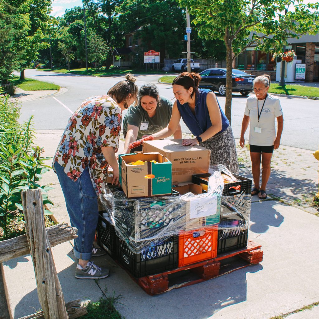 Staff and volunteers unloading a Feed the Need order