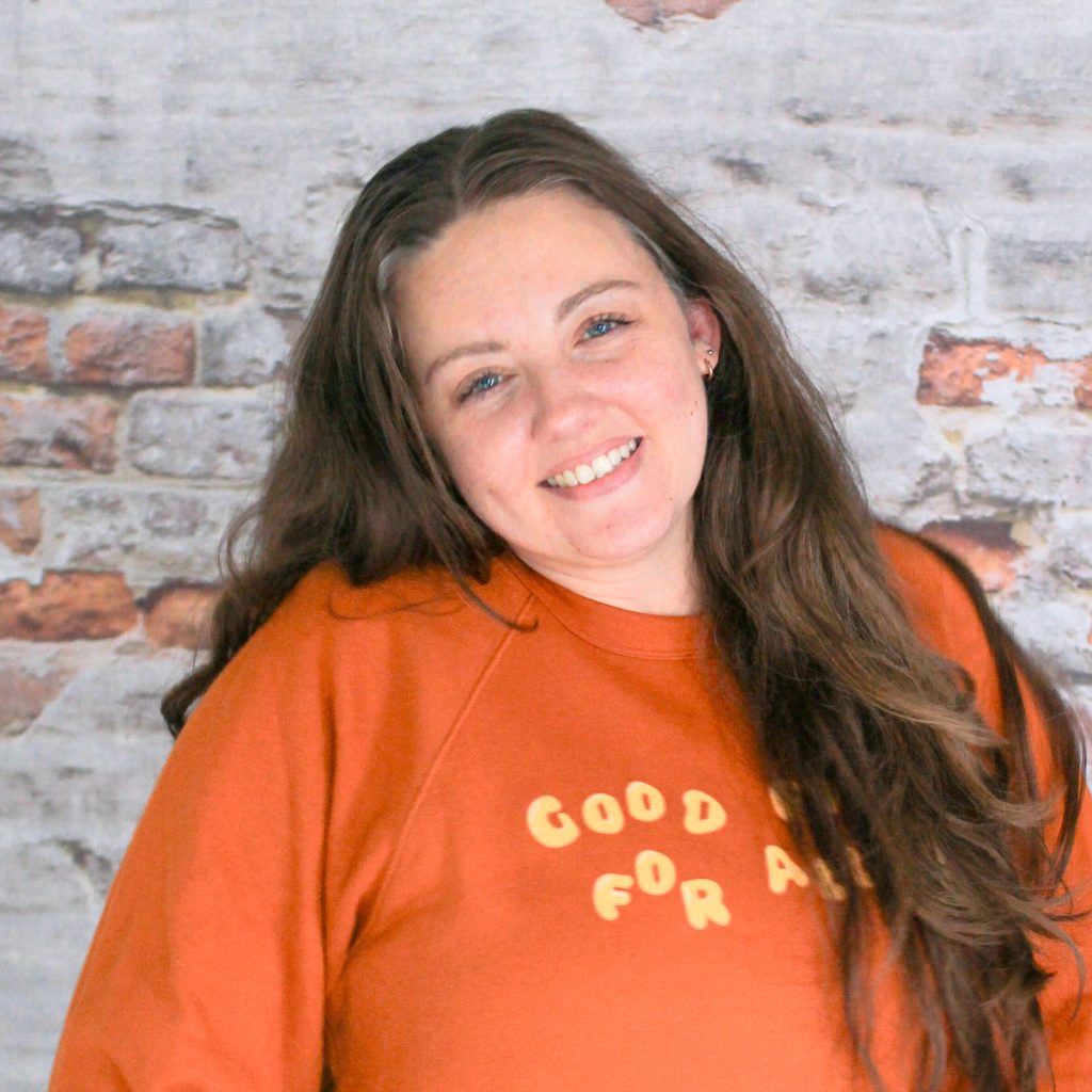 Headshot of Tiff, our Markets Coordinator, in front of a brick wall.